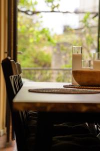a table with a bowl on it and a window at Les Lauriers Roses - Maison d'Hôtes in Barjac +9 photos