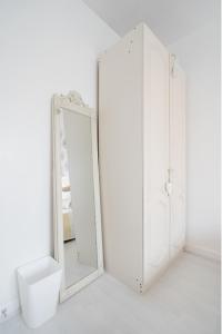 a bathroom with two white cabinets and a mirror at Tropical Garden Oasis Rooms in Birmingham