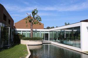 a house with a pond in front of it at FH Hotel Rural in Felgueiras