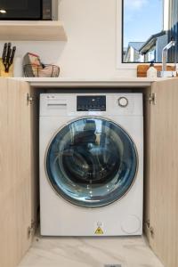 a washer and dryer in a kitchen at Stroll through the park 2 bed 2 bath w/carpark in Christchurch