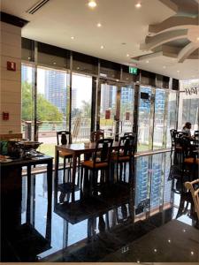 a dining room with tables and chairs in a restaurant at Cosmos Living Luxurious Studio Near Metro in Dubai