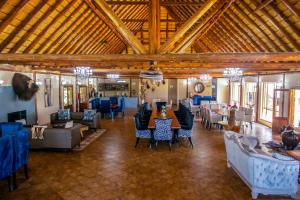 a large room with tables and chairs in a building at Mela Luxury Game Lodge in Pretoria