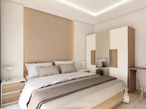 a white bedroom with a large bed in it at Apartments Villa Subic in Rab