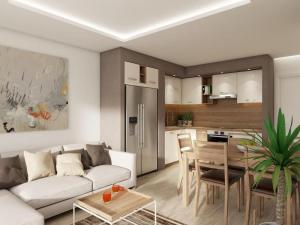 ein Wohnzimmer und eine Küche mit einem Sofa und einem Tisch in der Unterkunft Apartments Villa Subic in Rab
