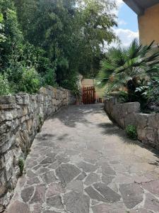 a stone walkway next to a stone wall at Adri's House in Monterotondo