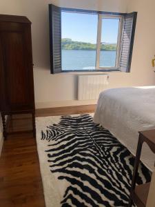 a bedroom with a zebra print rug and a window at 4 Harbour Town House in Westport