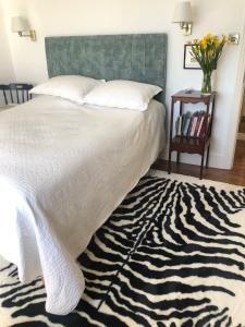 a bed with a zebra print rug in a bedroom at 4 Harbour Town House in Westport
