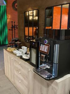 a coffee shop with a coffee machine on a counter at HOTEL TECH in Brembate
