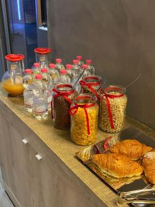 a counter with several jars of food and bread at HOTEL TECH in Brembate