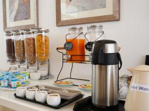 a coffeemaker sitting on a counter with food at The Maltese Sun in Sliema