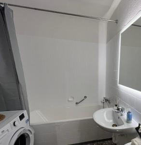a bathroom with a sink and a tub and a toilet at SW05-FW Apartment in Schweinfurt in Schweinfurt