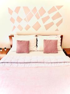 a bedroom with a bed with two pillows at Eleonora Home in Porto Torres