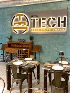 a restaurant with tables and chairs and a sign at HOTEL TECH in Brembate