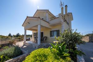 a villa with a view of a house at Tzaneta's star view in Kefallonia
