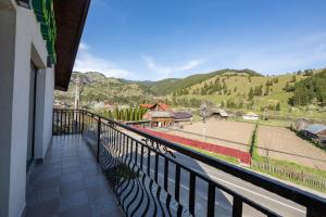 a balcony with a view of a train yard at CASA DE LA MUNTE in Frumosu