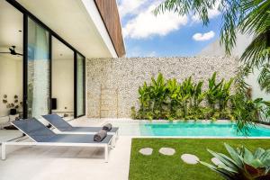 an indoor swimming pool in a house at Casa Umalas Villa by Betterplace in Canggu