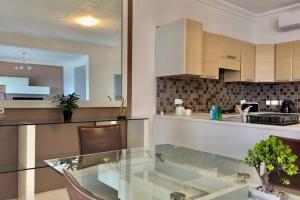 a kitchen with a glass table in a kitchen at sea view apartment on Sliema Promenade in Sliema