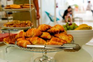 a plate of pastries on a table with other foods at The Maltese Sun in Sliema