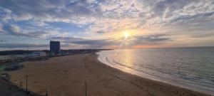 a view of a beach with the sun setting at Beautiful Beach Side 4 Bed House in Kent