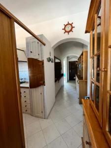 a large kitchen with a clock on the ceiling at bilocale vista porto in Cannigione +6 photos