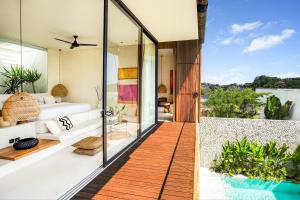 a room with a view of the ocean from a house at Casa Umalas Villa by Betterplace in Canggu