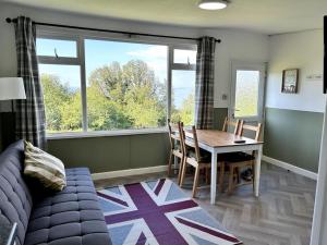 a living room with a table and a couch at Sea Valley 33 Bideford Bay Holiday Park in Bideford