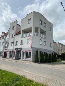 a building on the side of a street at Apartament DeLux in Pasłęk