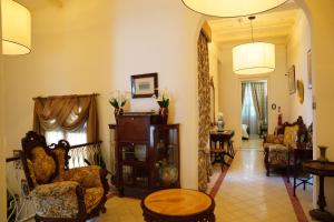 a living room with several chairs and a table at The Maltese Sun in Sliema