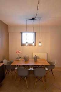 a dining room with a wooden table and chairs at Iasonas House 85m2 in Preveza +36 photos