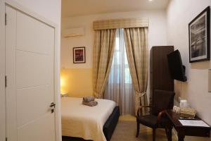 a hotel room with a bed and a window at The Maltese Sun in Sliema