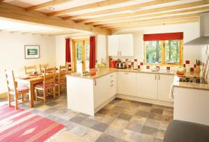 a kitchen and dining room with a table and chairs at Deerpark Lodge in Ashby de la Zouch