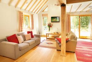 a living room with a couch and a tv at Deerpark Lodge in Ashby de la Zouch