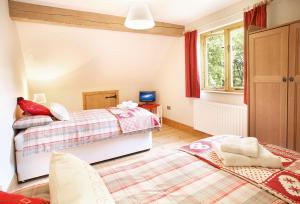 a bedroom with two beds and a window at Deerpark Lodge in Ashby de la Zouch
