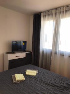 a bedroom with a bed with two towels on it at Apartman Snezana in Pirot