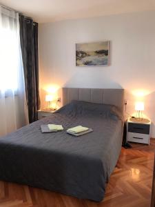 a bedroom with a bed with two towels on it at Apartman Snezana in Pirot