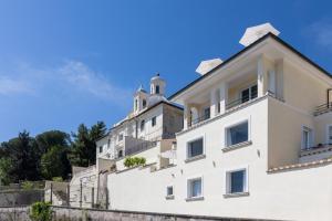 a white building with a tower on top of it at Monastero dei Santi in Rome