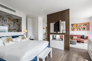 a bedroom with a large bed and a living room at Monastero dei Santi in Rome