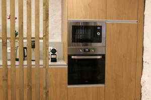 a kitchen with a microwave and a oven at Quinta de Chousas - Braga - Agroturismo in Braga