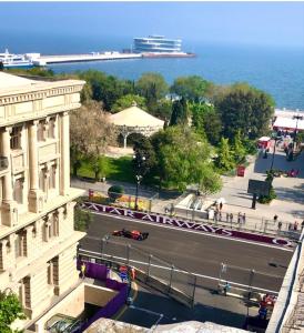 a city street with a cruise ship in the water at Cozy studio, Center, Sea view in Baku