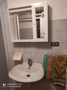 a bathroom with a white sink and a mirror at Baita "Lou Tzatagni" Pialemont Champorcher - CIR VDA - PONTBOSET 0002 in Pontboset