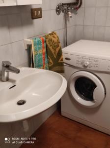 a bathroom with a sink and a washing machine at Baita "Lou Tzatagni" Pialemont Champorcher - CIR VDA - PONTBOSET 0002 in Pontboset