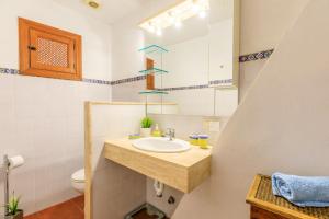 a bathroom with a sink and a toilet at Casa Torres in Pollença +26 photos