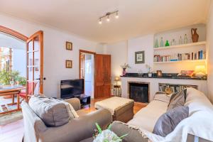 a living room with two couches and a fireplace at Casa Torres in Pollença