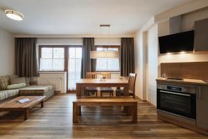 a living room with a table and a couch at Appartement Oberwirt Ferienwohnung in Ebbs +14 photos