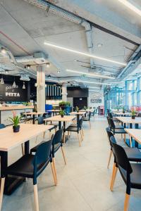 a dining room with tables and chairs in a restaurant at Apartamenty Collegia in Gdańsk