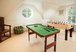a living room with a pool table and a table at The Oaks in All Stretton