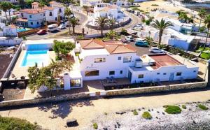 an aerial view of a house with a swimming pool at Hélène Holidays - Hotel Boutique in Corralejo