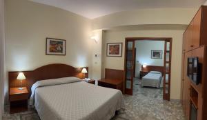 a hotel room with a bed and a mirror at Il Nocchiero City Hotel in Soverato Marina