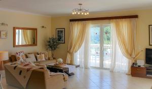 a living room with a couch and a table at Villa Kyriaki in Kalami