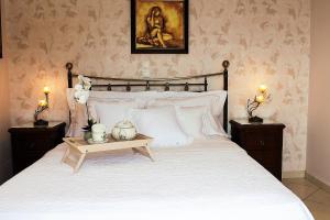 a bedroom with a large white bed with two night stands at Villa Kyriaki in Kalami +32 photos